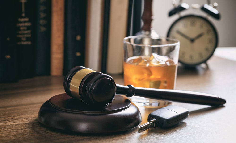 Gavel and a glass of whiskey on a table