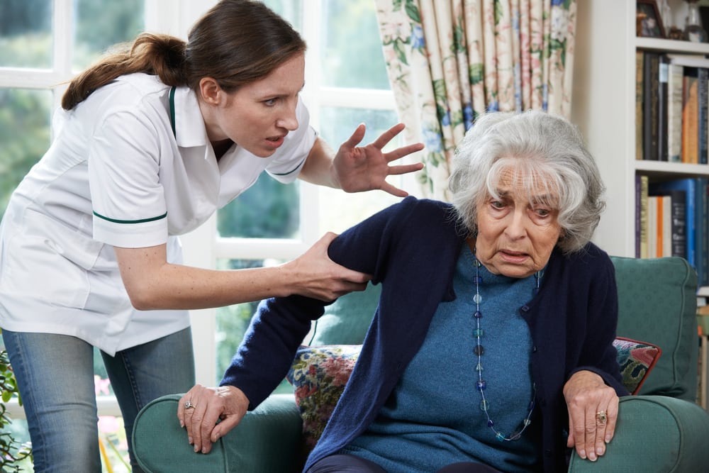 Photo of Worker Mistreating Senior Woman