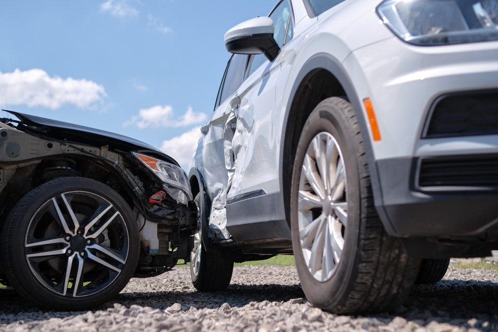 Car accident involving a white SUV and a black sedan