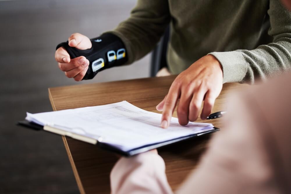 A photo of an injured client's hand and arm