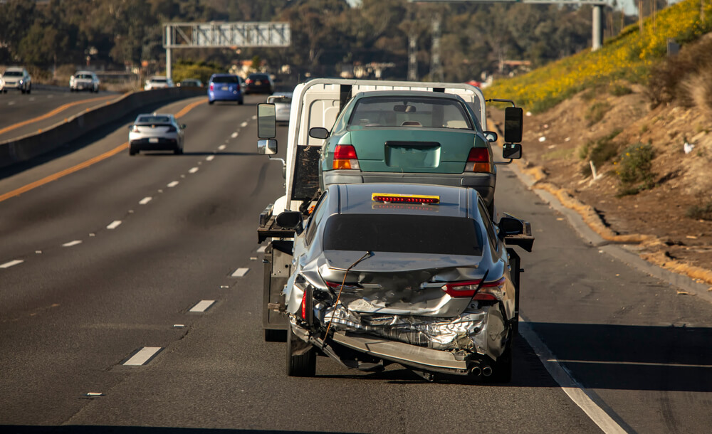 A photo of a car crashed into a truck